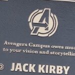 Jack Kirby plaque at Avengers Campus at Disney California Adventure, with the Avengers logo and the dedication line Avengers Campus owes much to your vision and storytelling
