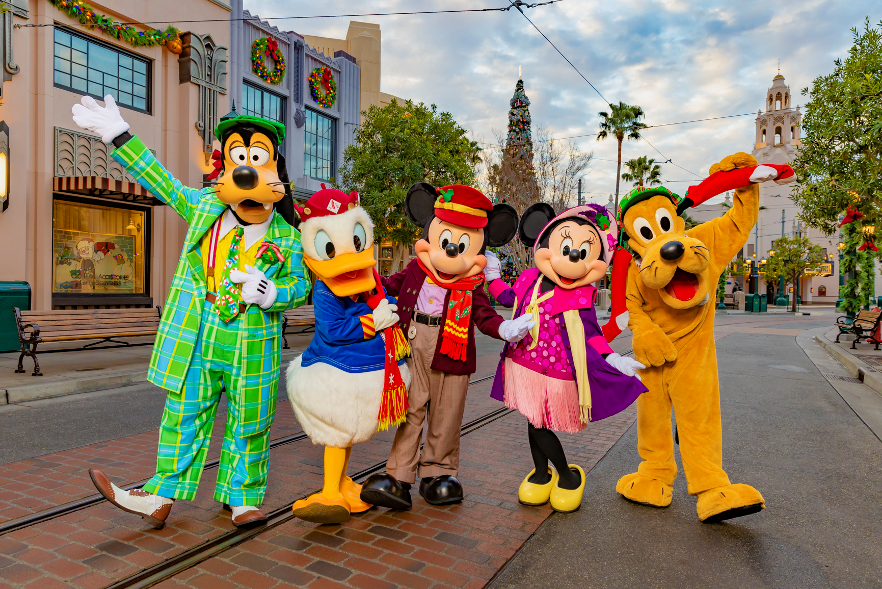 Goofy, Donald Duck, Mickey Mouse, Minnie Mouse and Pluto in winter attire on Buena Vista Street at Disney California Adventure