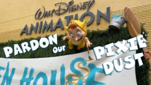 The Lost Boy figure from Back to Neverland paints an Open House banner beneath the Walt Disney Animation lettering at Disney's Hollywood Studios, on the title card for the Pardon Our Pixie Dust episode.