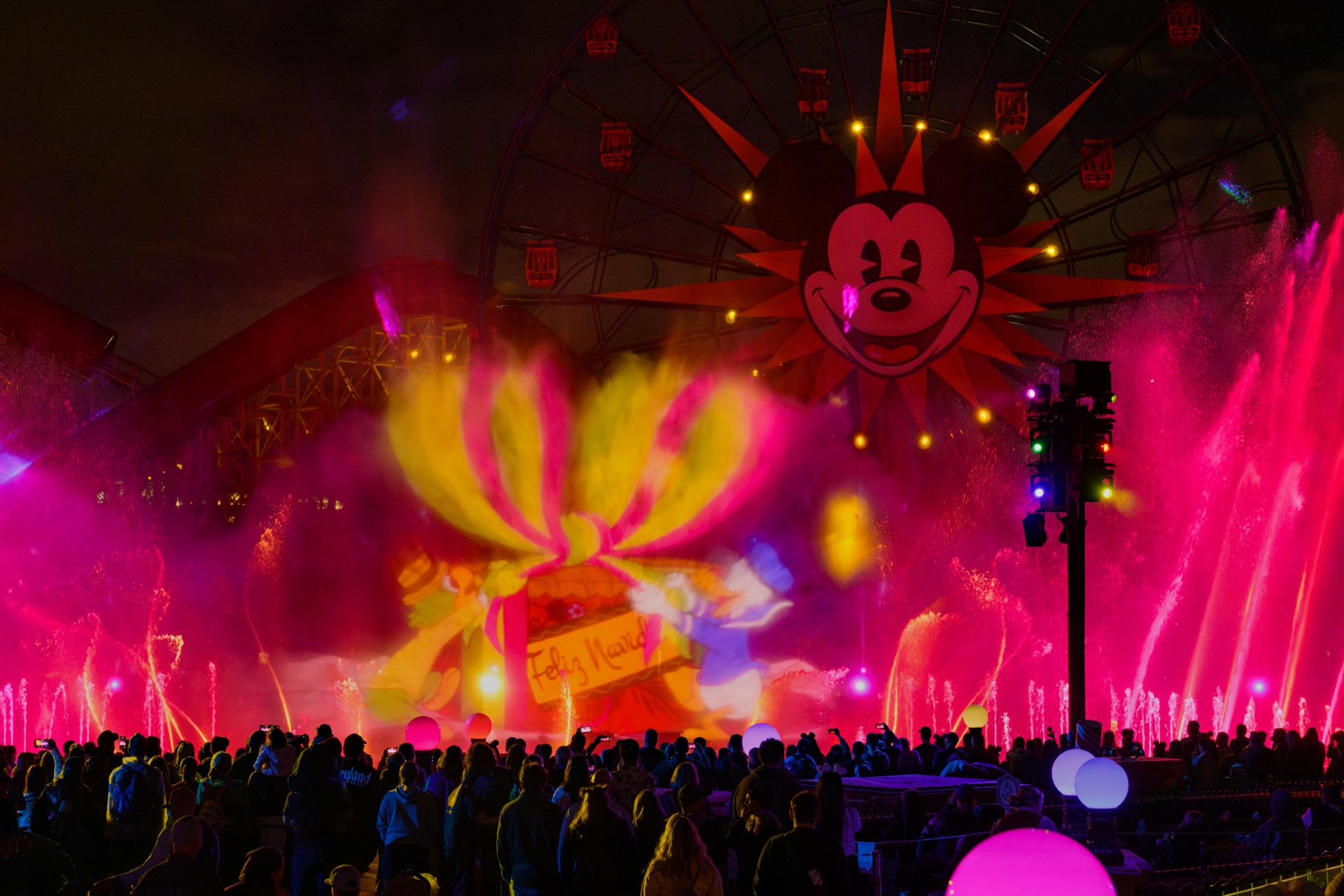 World of Color - Season of Light at Disney California Adventure, with colorful fountains in Paradise Bay and Mickey's face lit on the Pixar Pal-A-Round