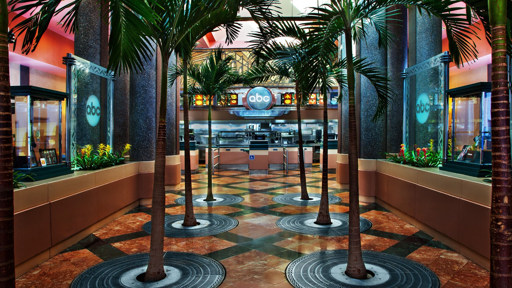 Two rows of palm trees adorn the interior entryway to ABC Commissary at Disney's Hollywood Studios