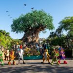 Characters and performers gathered in front of the Tree of Life at Disney's Animal Kingdom for the park's 25th anniversary