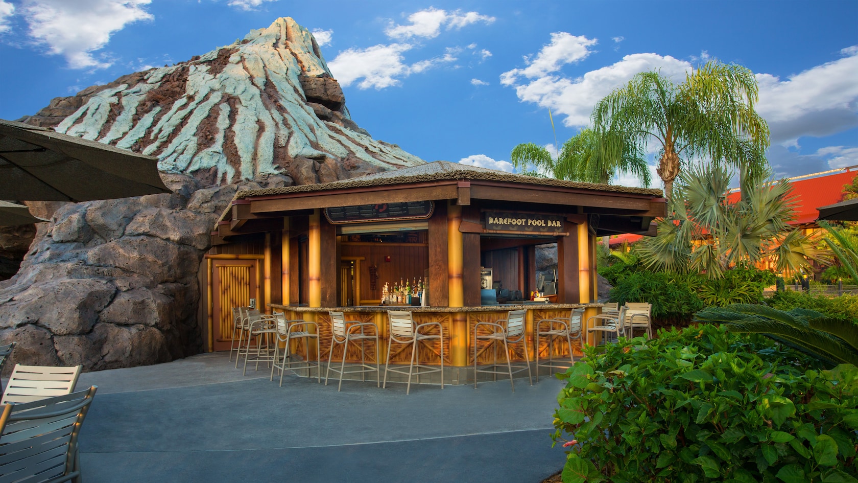 Exterior view of Barefoot Pool Bar at Disney's Polynesian Resort, with Nanea Volcano in the background