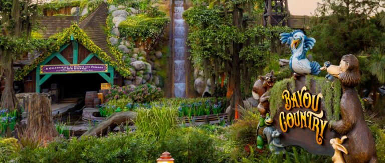 The Bayou Country sign, decorated with animal figures, surrounded by lush greenery