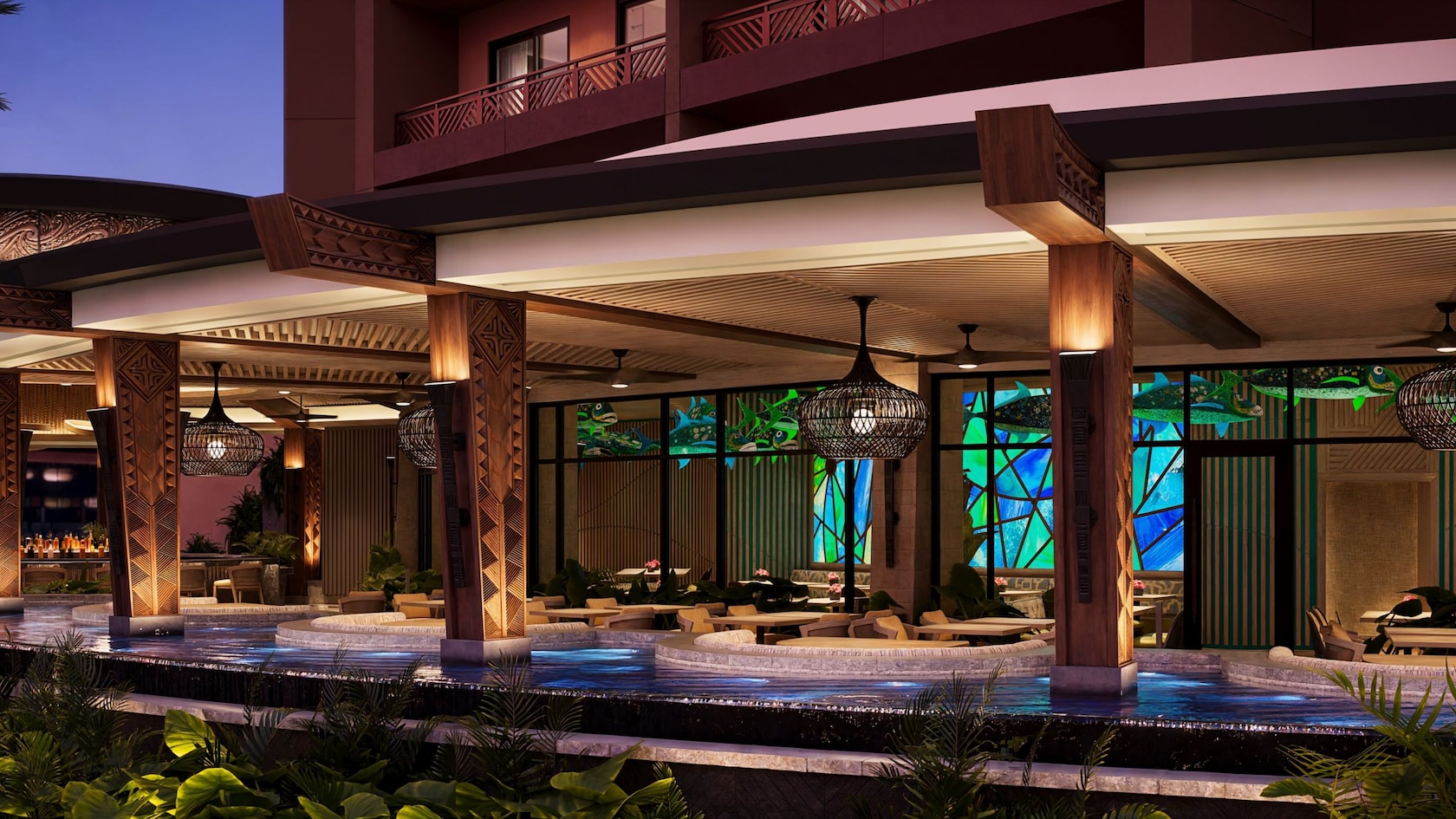Outdoor seating area by a water feature at the Island Tower of Disney’s Polynesian Villas and Bungalows