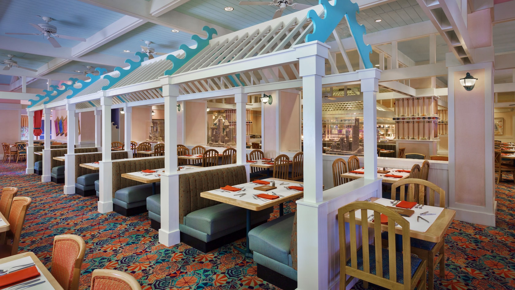 Booth seating under cabana-like structures inside the dining area at Cape May Café