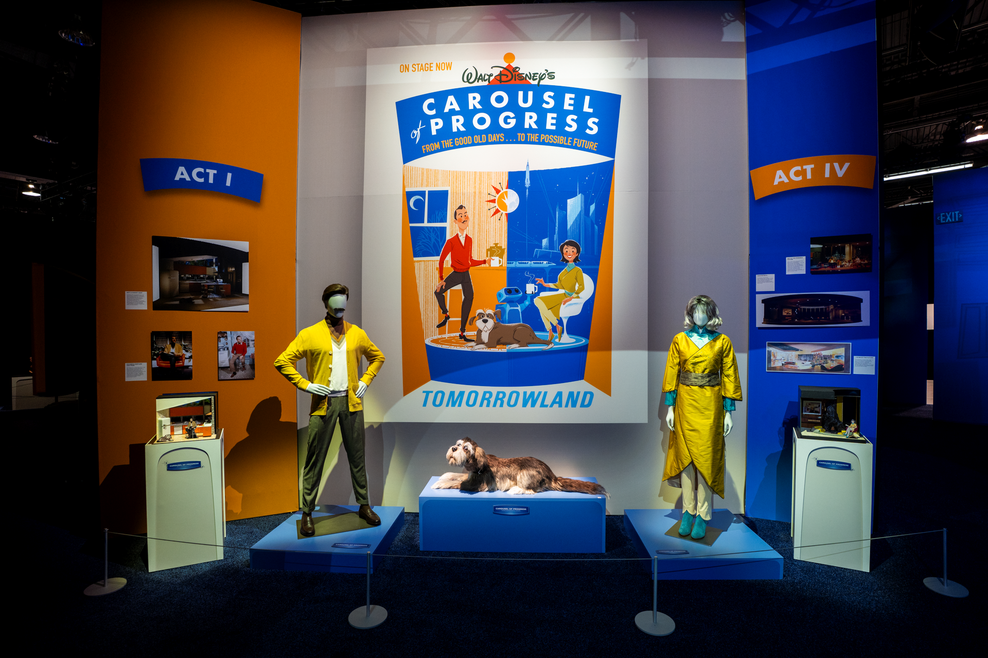Walt Disney's Carousel of Progress display at D23 with the new yellow costumes for the father and mother on mannequins, two scene models and a Carousel of Progress poster