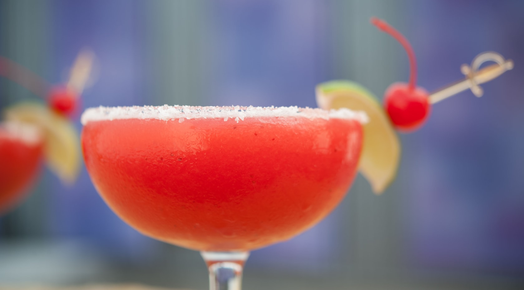Close-up of cocktail on the rocks with a slice of lime