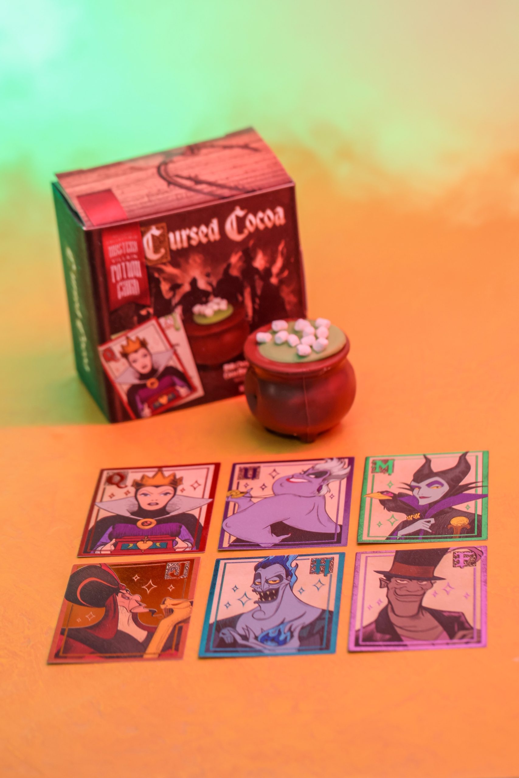 Cursed Cocoa box and cauldron with six Disney Villains potion cards laid out in front