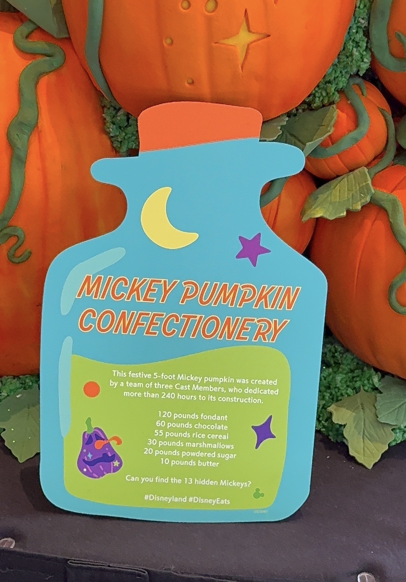 Mickey Pumpkin Confectionery sign listing 240 hours of work by three Cast Members and the pounds of fondant, chocolate, rice cereal, marshmallows, powdered sugar and butter used