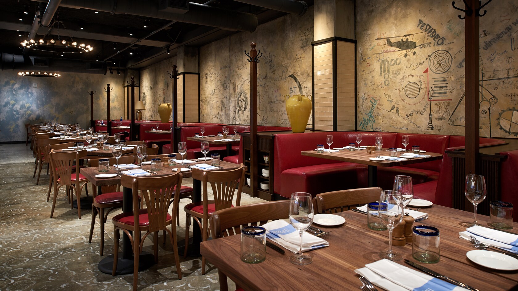 A restaurant with tables and booths set for dining