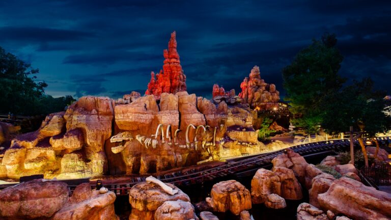 The red rock spires and track of Big Thunder Mountain Railroad at night