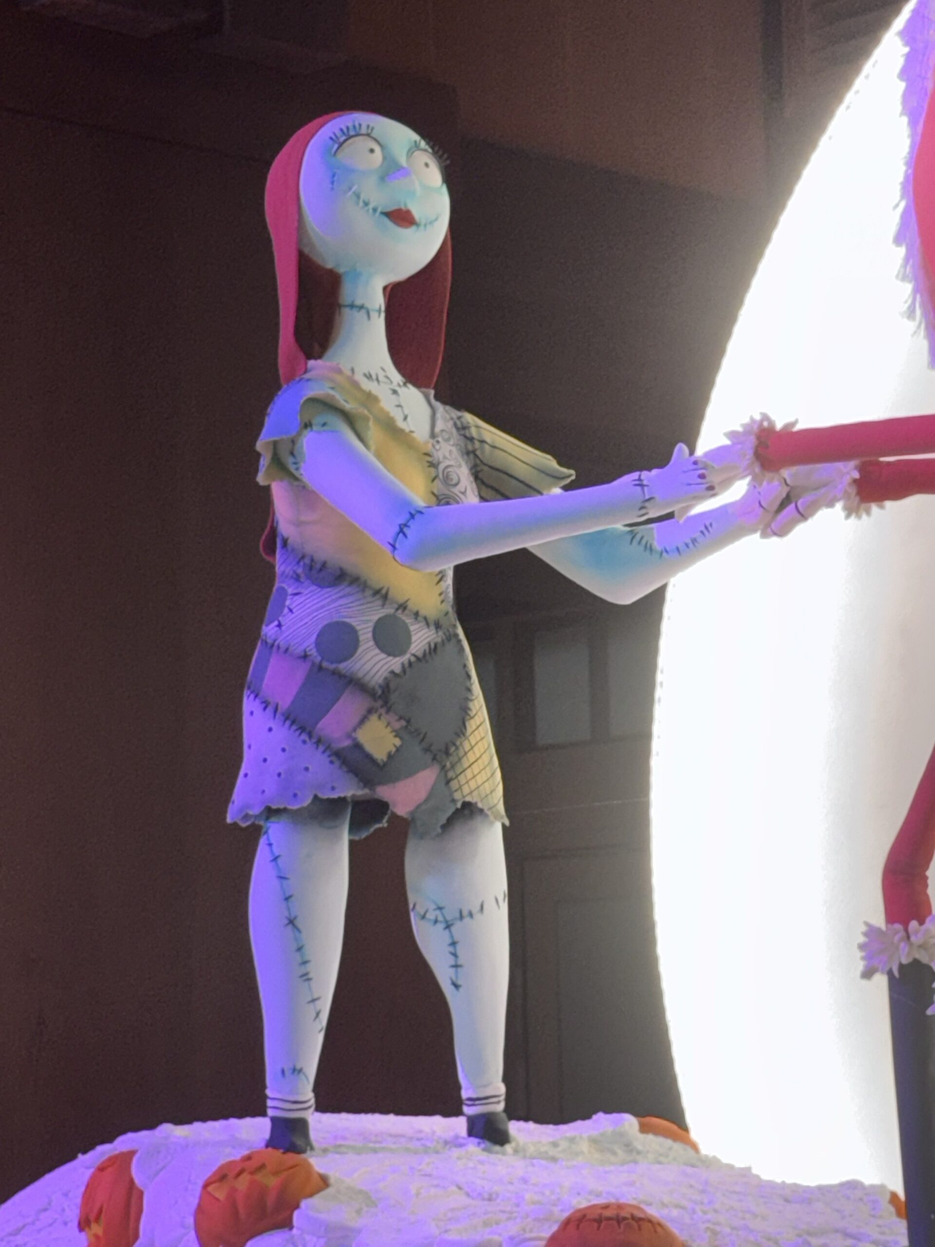 Close-up of the Sally confection figure in her patchwork dress on Spiral Hill at the Grand Californian