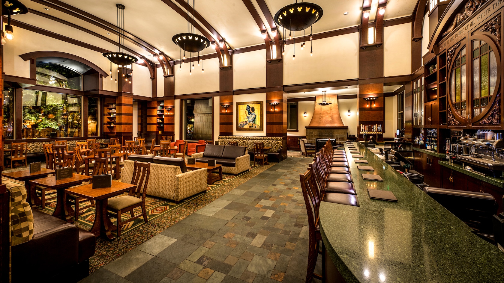 The lodge style interior of Hearthstone Lounge with dining tables , sofa seating and a bar.