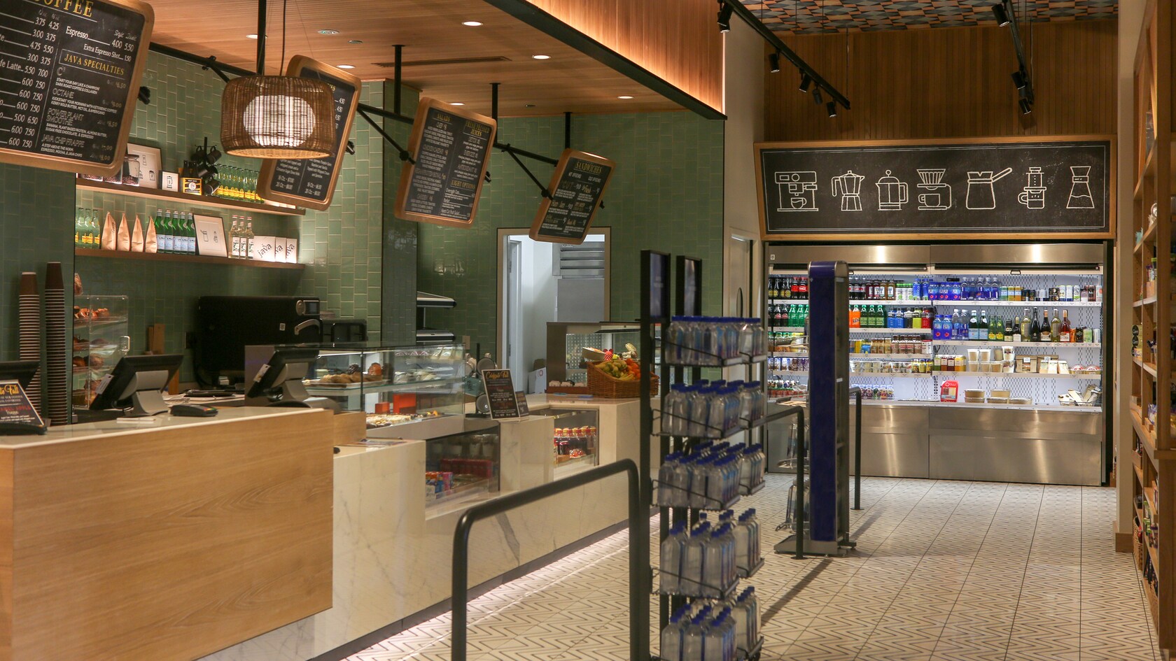 A contemporary cafe featuring a counter service ordering area and a refrigerator display case with take away beverages and snacks
