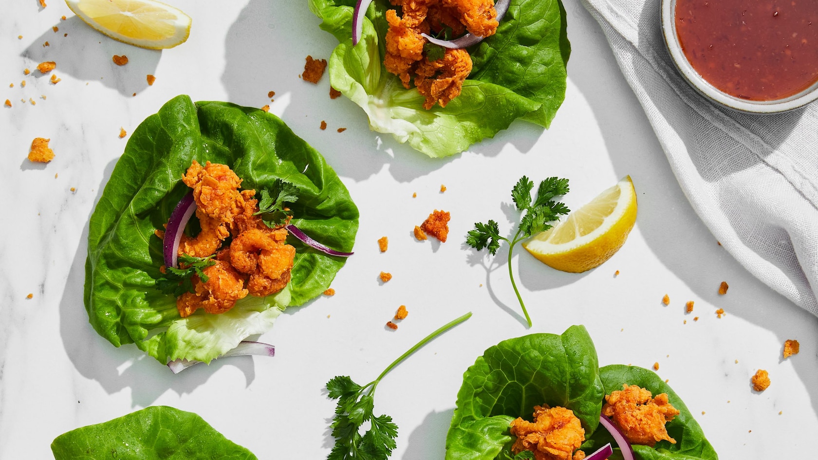 Fried crawfish lettuce wraps on a white tablecloth