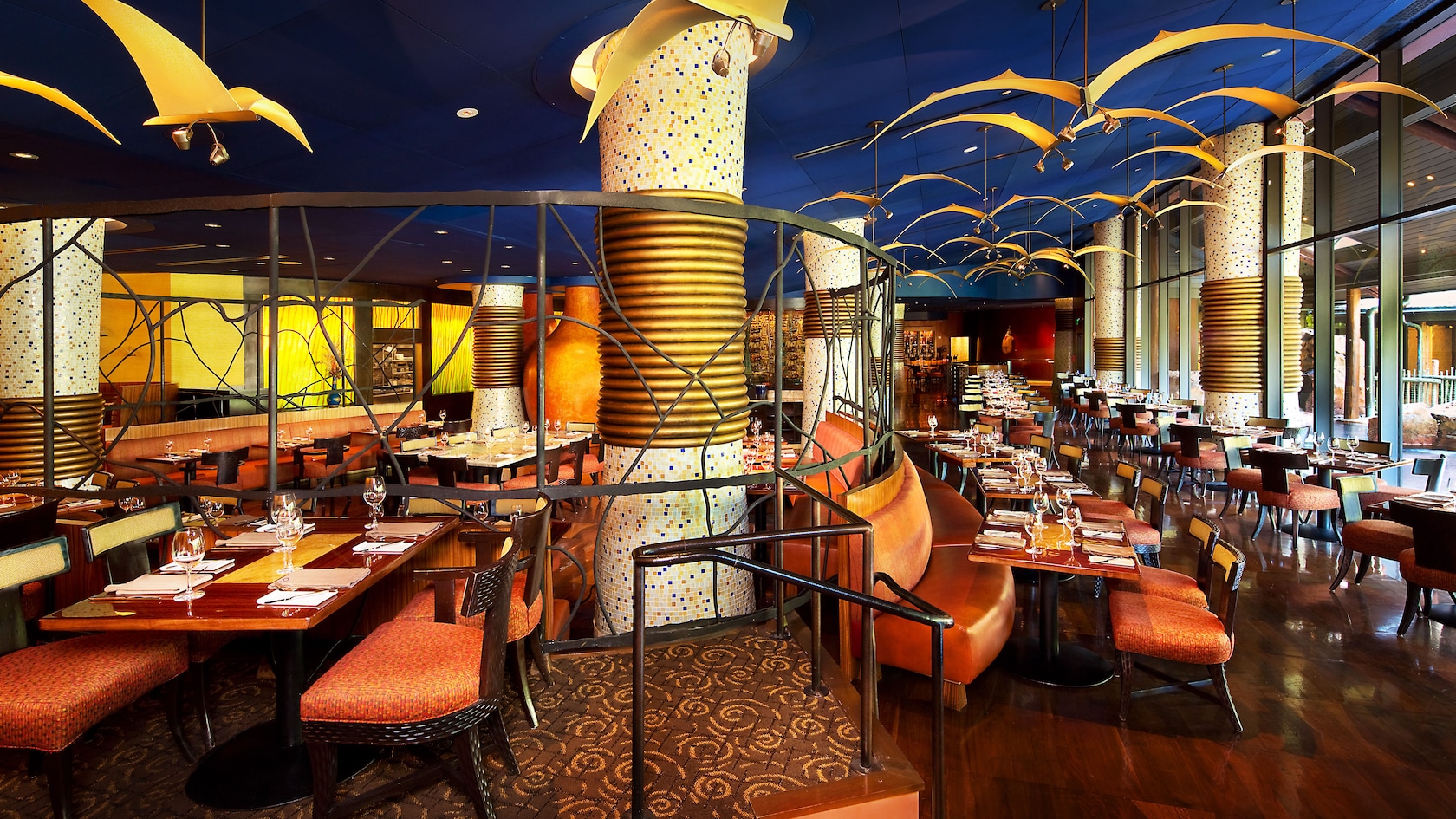 View from rear of dining room, showing hanging yellow bird sculptures