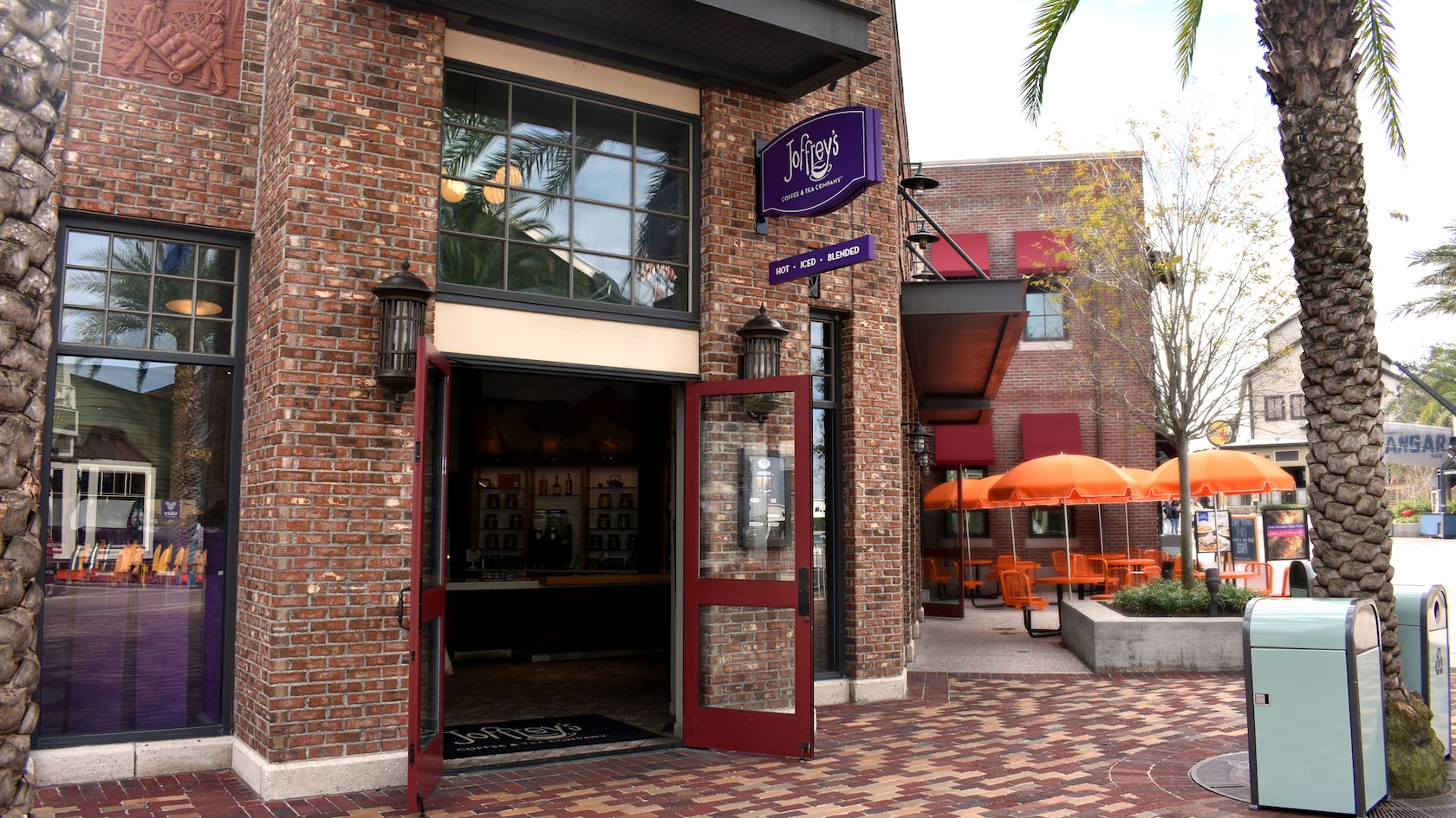 A brick faced Joffreys Coffee and Tea Company store with its front glass doors wide open