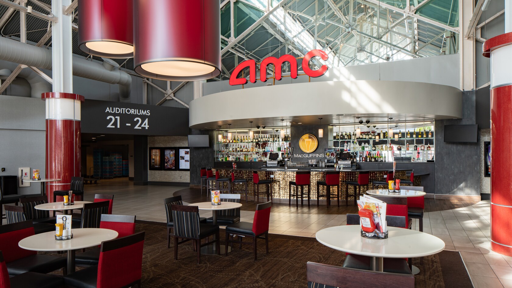 MacGuffins bar in the AMC Disney Springs lobby includes hightop tables with chairs