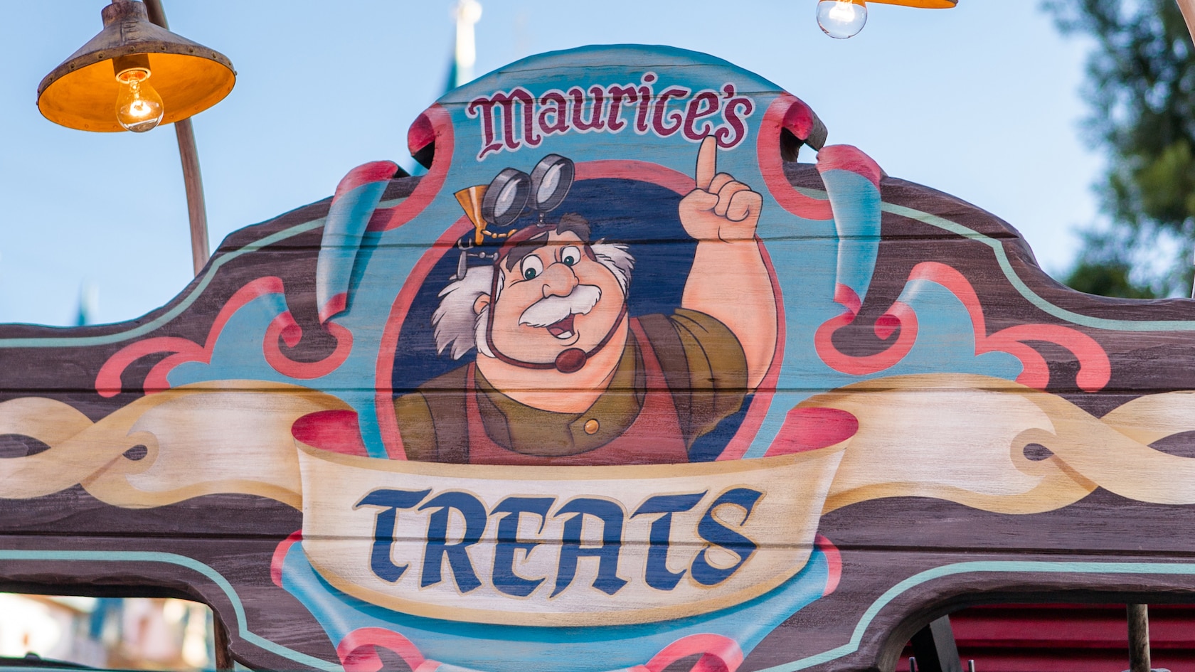 A colorful wooden sign at Fantasy Faire reads, ‘Maurice’s Treats’