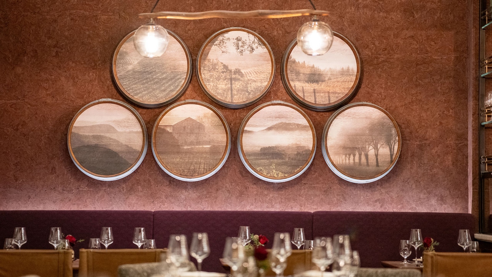 Vineyard photographs above a banquette at Napa Rose in Disney’s Grand Californian Hotel & Spa