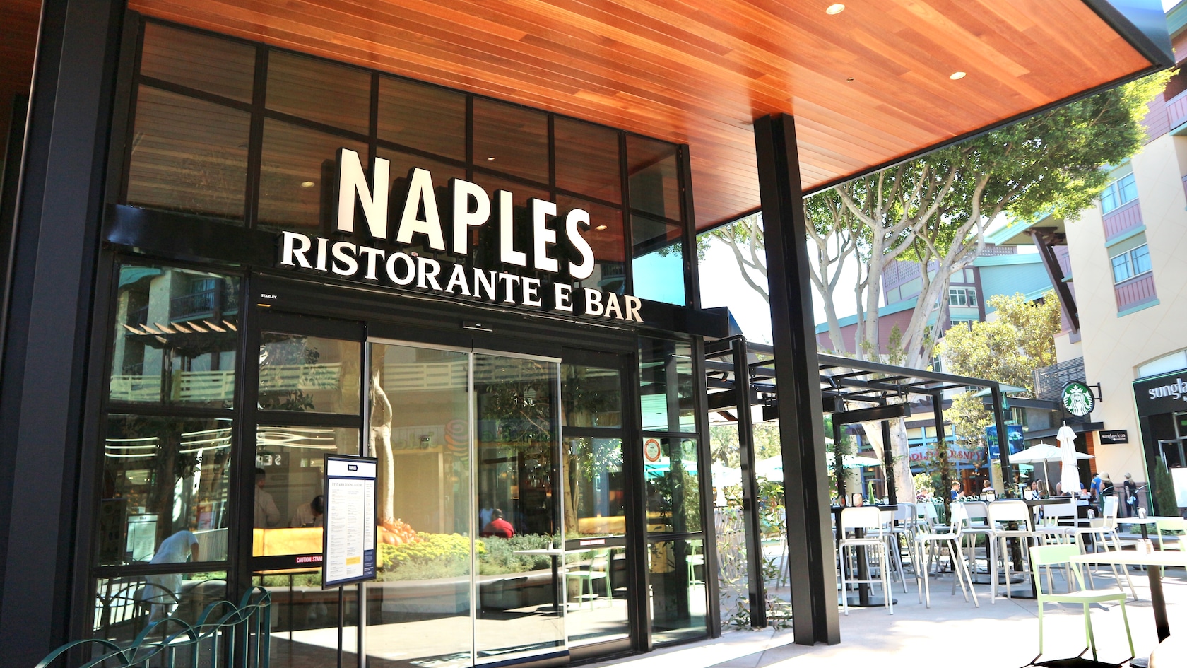 The modern style entrance to Naples Ristorante e Bar with outdoor seating