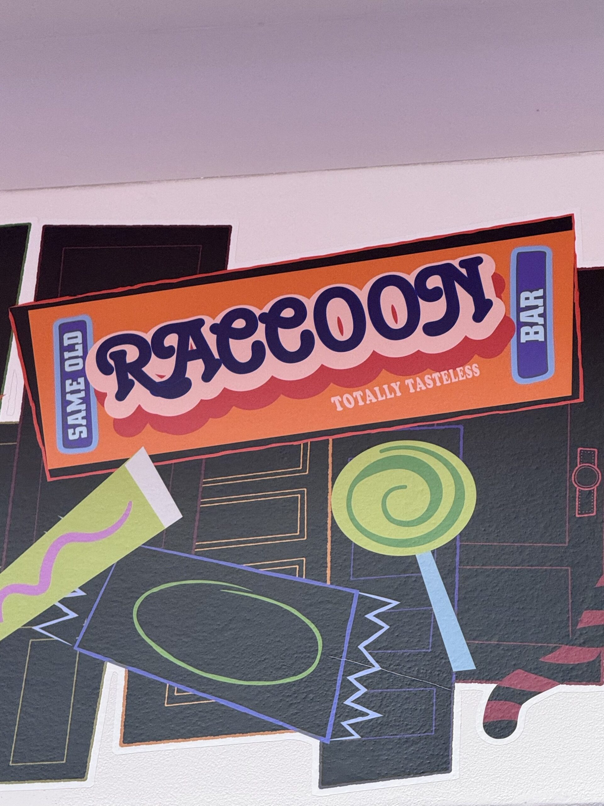 Same Old Raccoon Bar candy wrapper artwork labeled Totally Tasteless at Pixar Place Hotel