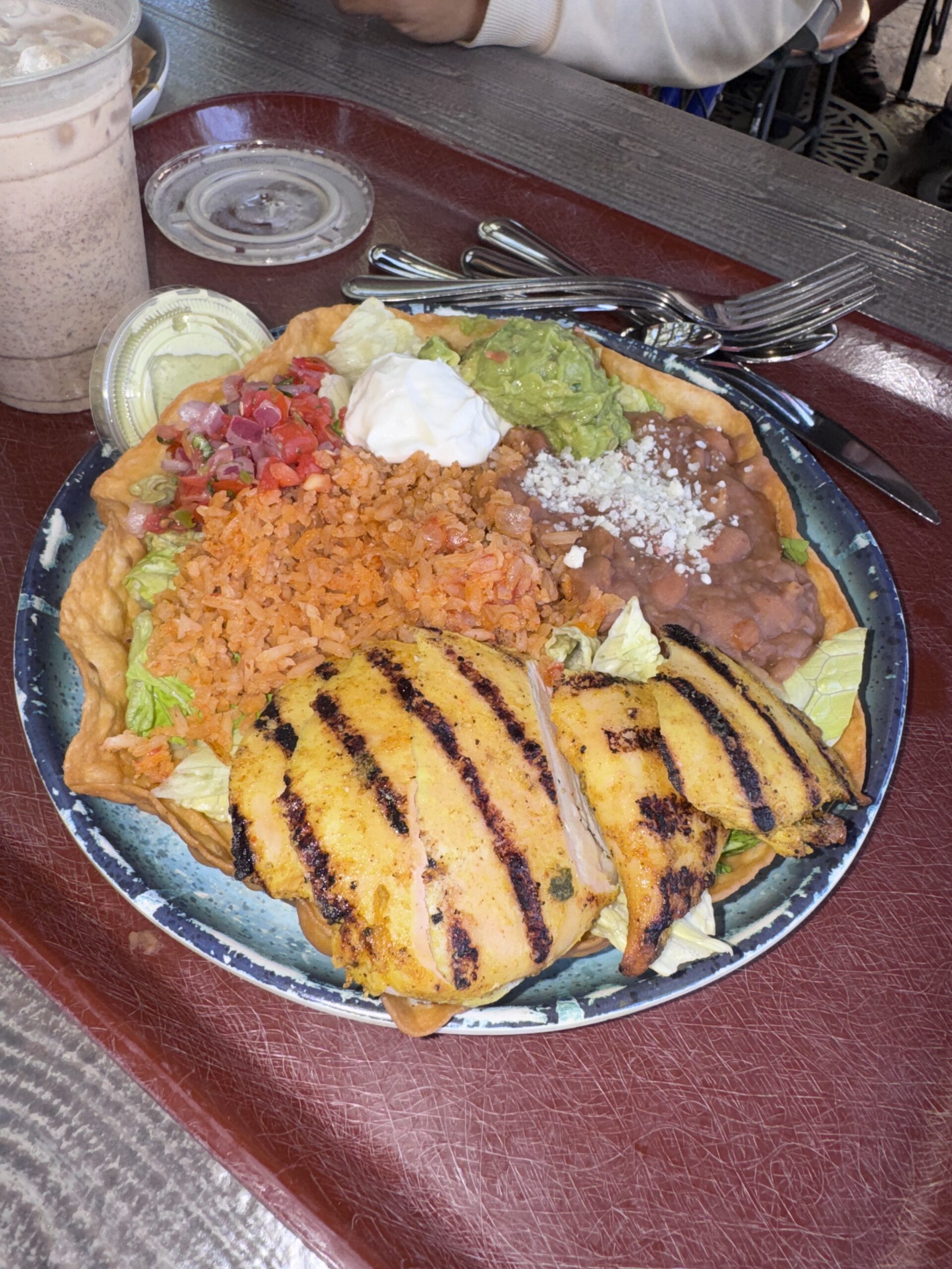 The new Chicken Tostada Salad at Rancho del Zocalo Restaurante in Disneyland, with grilled chicken, rice, beans, guacamole, sour cream and pico de gallo in a fried tortilla shell