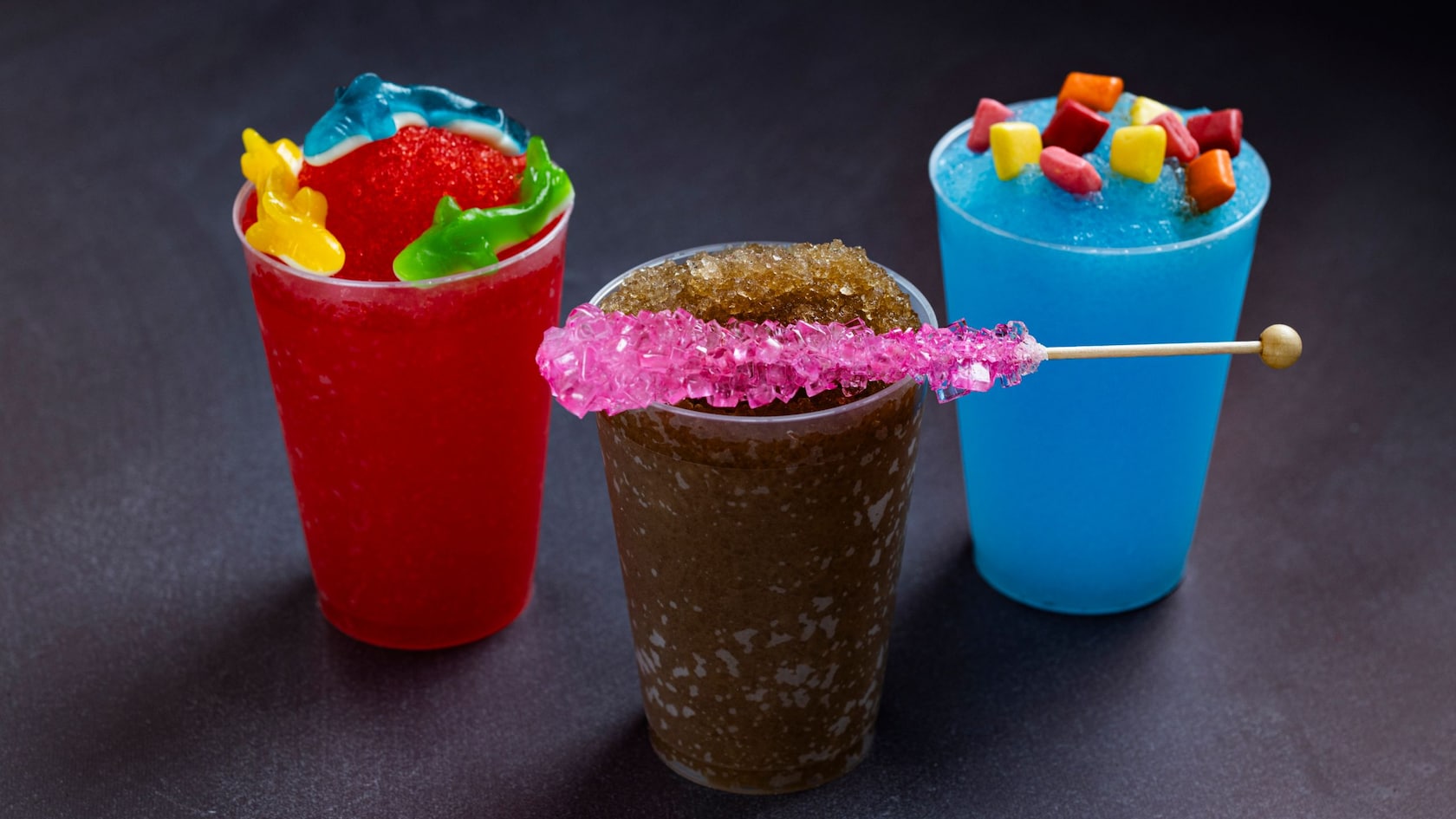 3 frozen drinks topped with assorted candies from Refreshment Station at Epcot