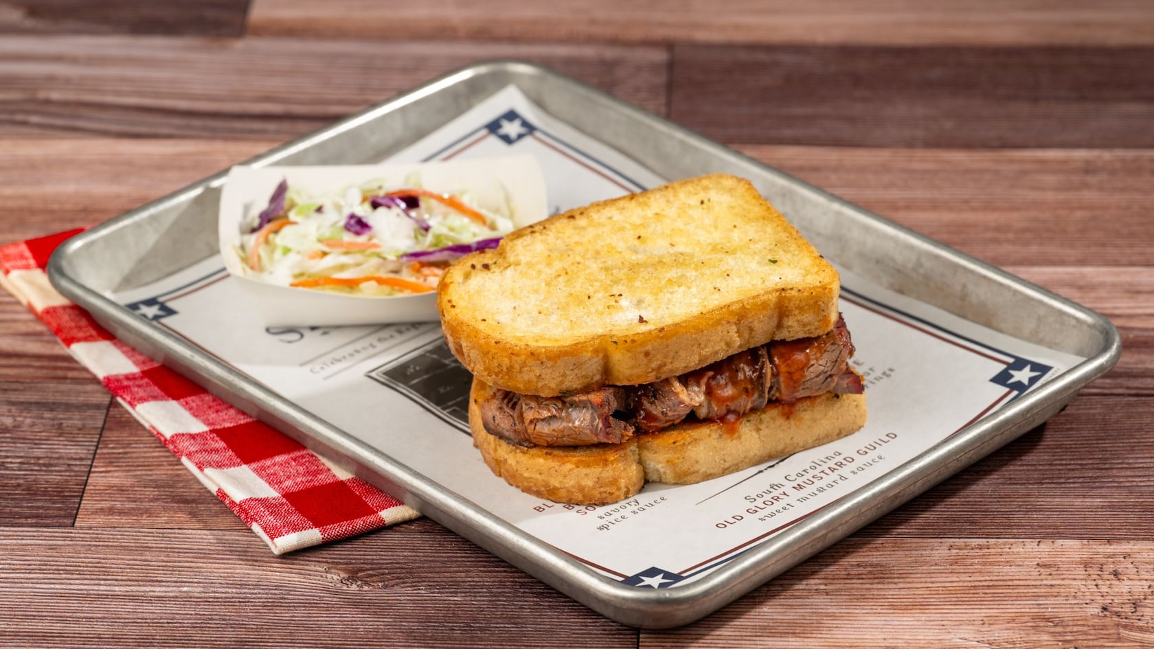 A barbeque sandwich served with coleslaw on a tray