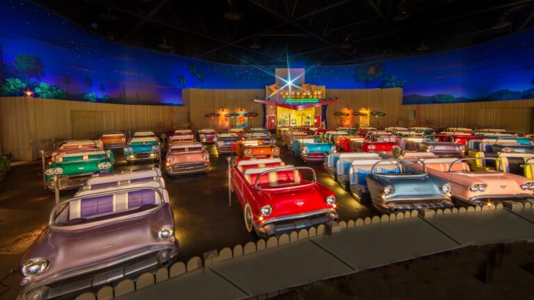 A fifties style drive in at dusk with rows of vintage cars at the Sci-Fi Dine-In Theater Restaurant