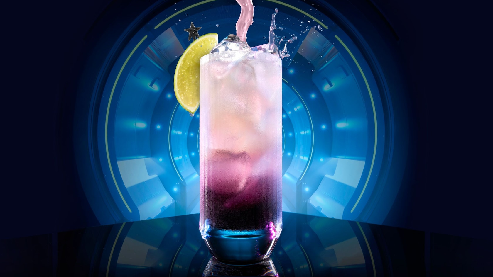A drink is poured into a glass and served with lime