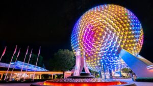 Spaceship Earth at EPCOT lit up in rainbow colors at night