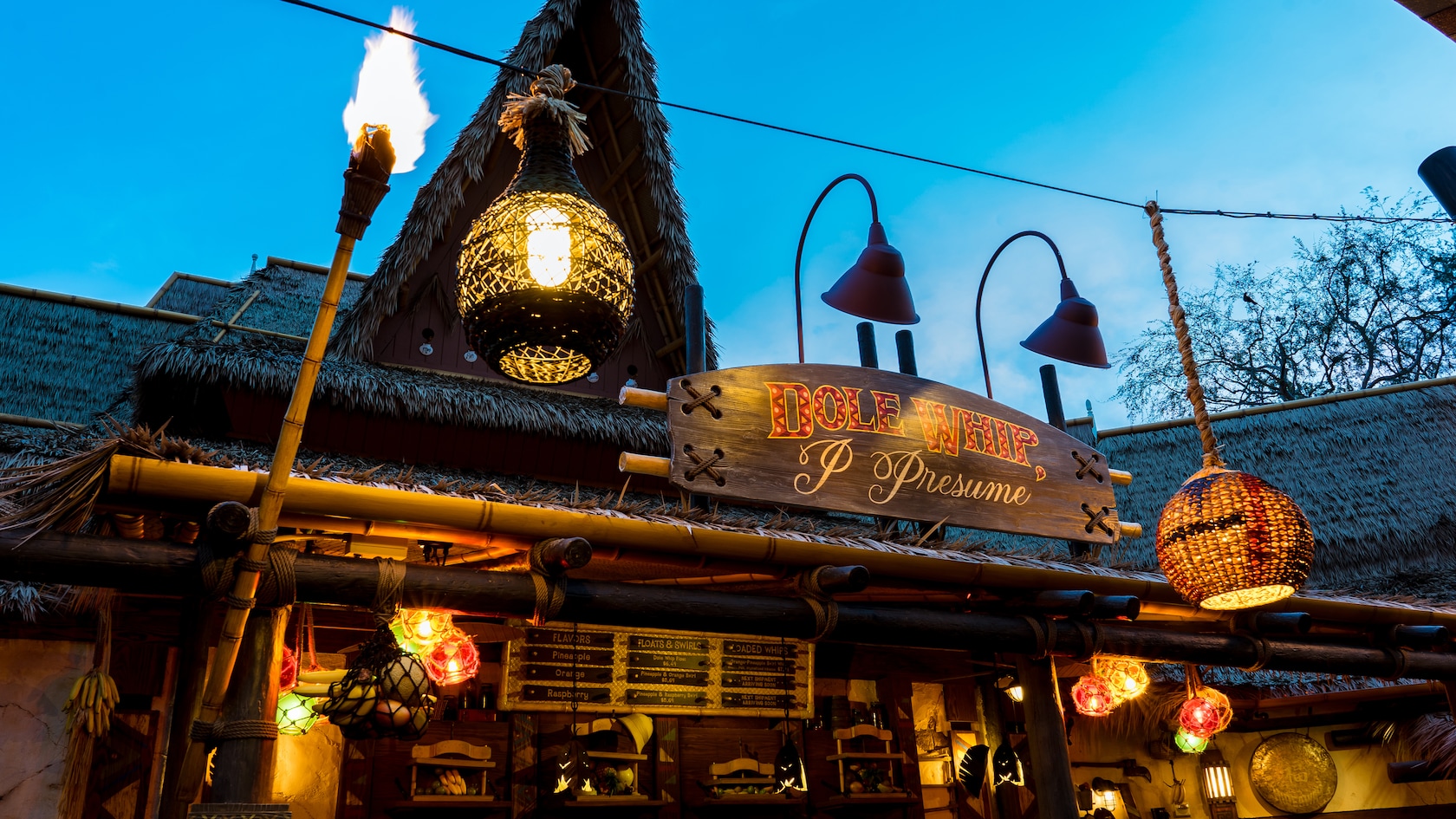 The exterior of The Tropical Hideaway lit at night