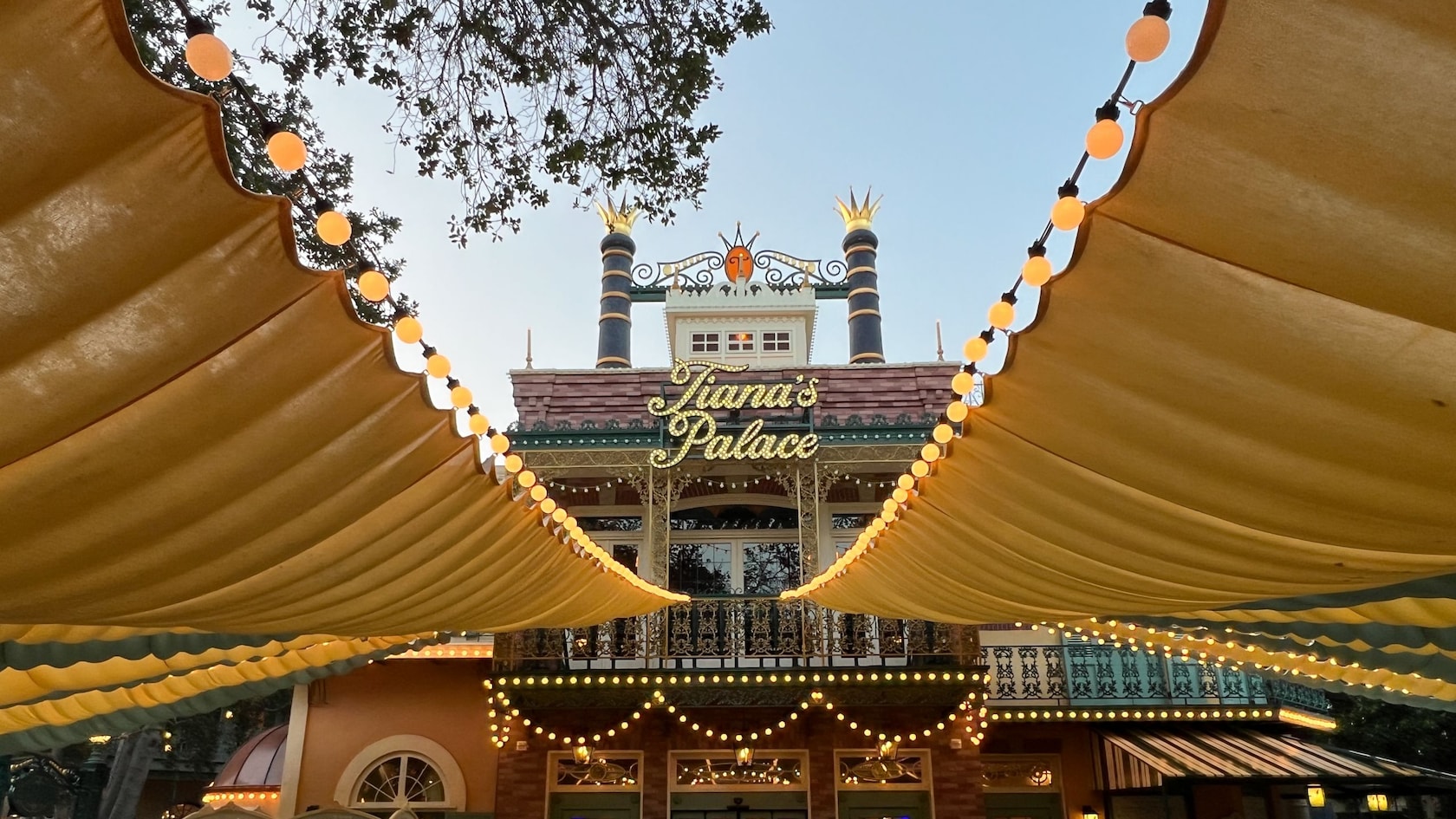 Tiana's Palace restaurant entrance under decorative string lights and canopies