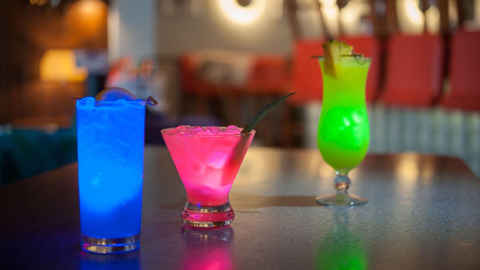Three specialty cocktails, each a different color