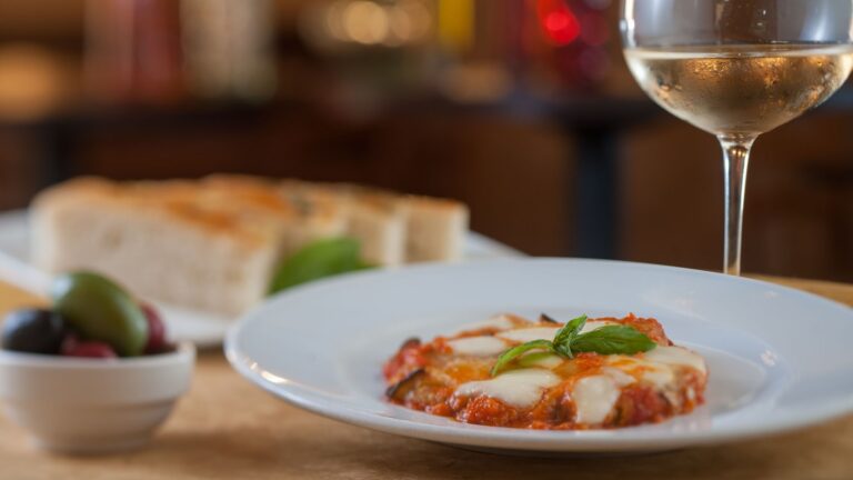 Baked zucchini appetizer topped with pomodoro, mozzarella and parmesan