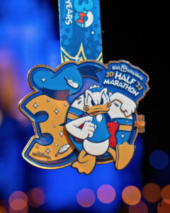 2027 Walt Disney World Half Marathon medal shaped like a 30 with Donald Duck