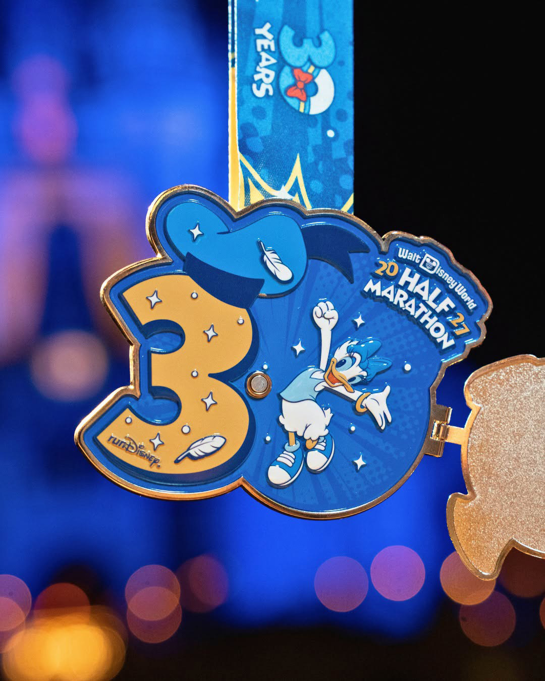 2027 Walt Disney World Half Marathon medal opened to reveal Daisy Duck