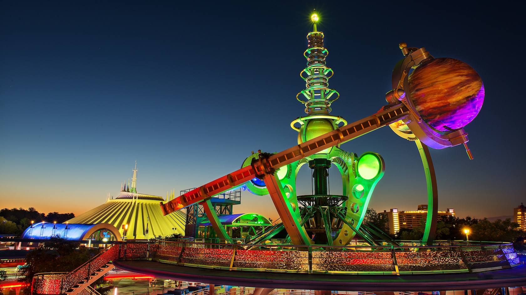 The Astro Orbiter tower lit up above Tomorrowland at Magic Kingdom