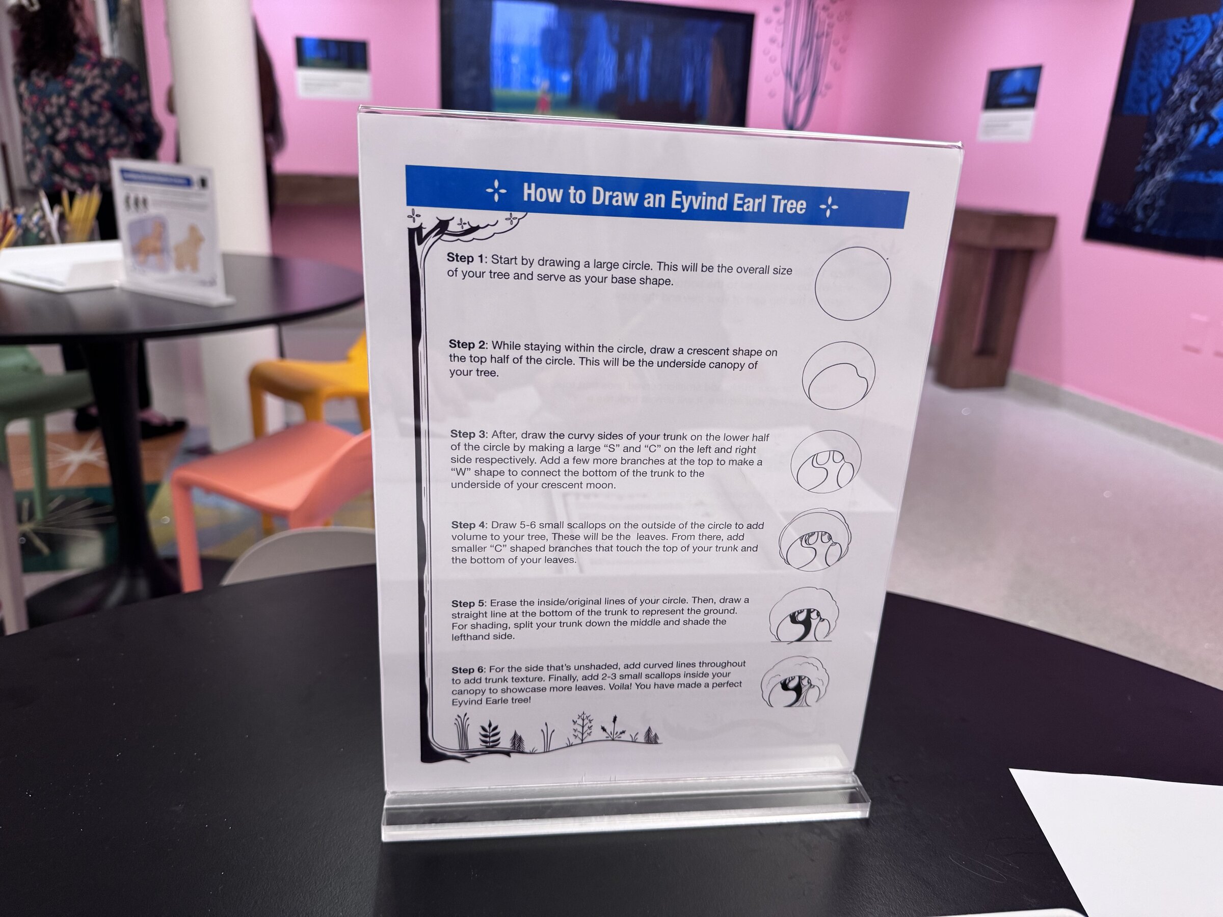 A How to Draw an Eyvind Earle Tree step-by-step sign on an activity table at The Walt Disney Family Museum