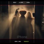 Three silhouettes matching the Sanderson sisters in a smoky, backlit doorway, framed by a camera monitor display, from Bette Midler's Oct. 1 Instagram post