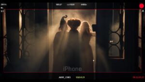 Three silhouettes matching the Sanderson sisters in a smoky, backlit doorway, framed by a camera monitor display, from Bette Midler's Oct. 1 Instagram post