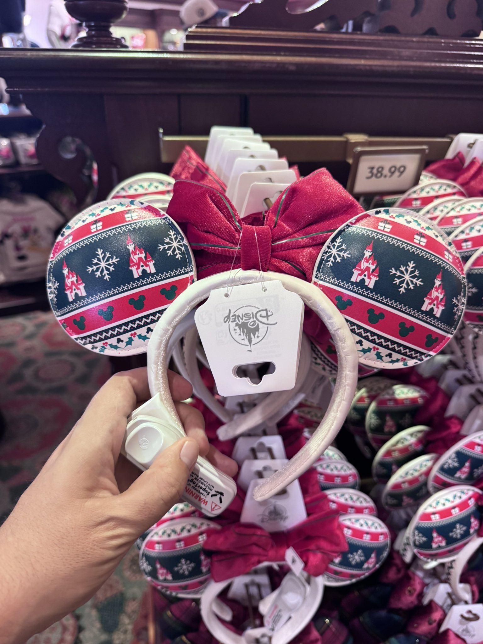 A display of Christmas sweater-pattern Minnie ears at the Emporium at Disneyland