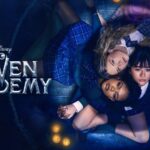 Coven Academy key art showing three students in plaid school uniforms lying in a circle on a wooden floor surrounded by candles, beside the Disney Coven Academy logo