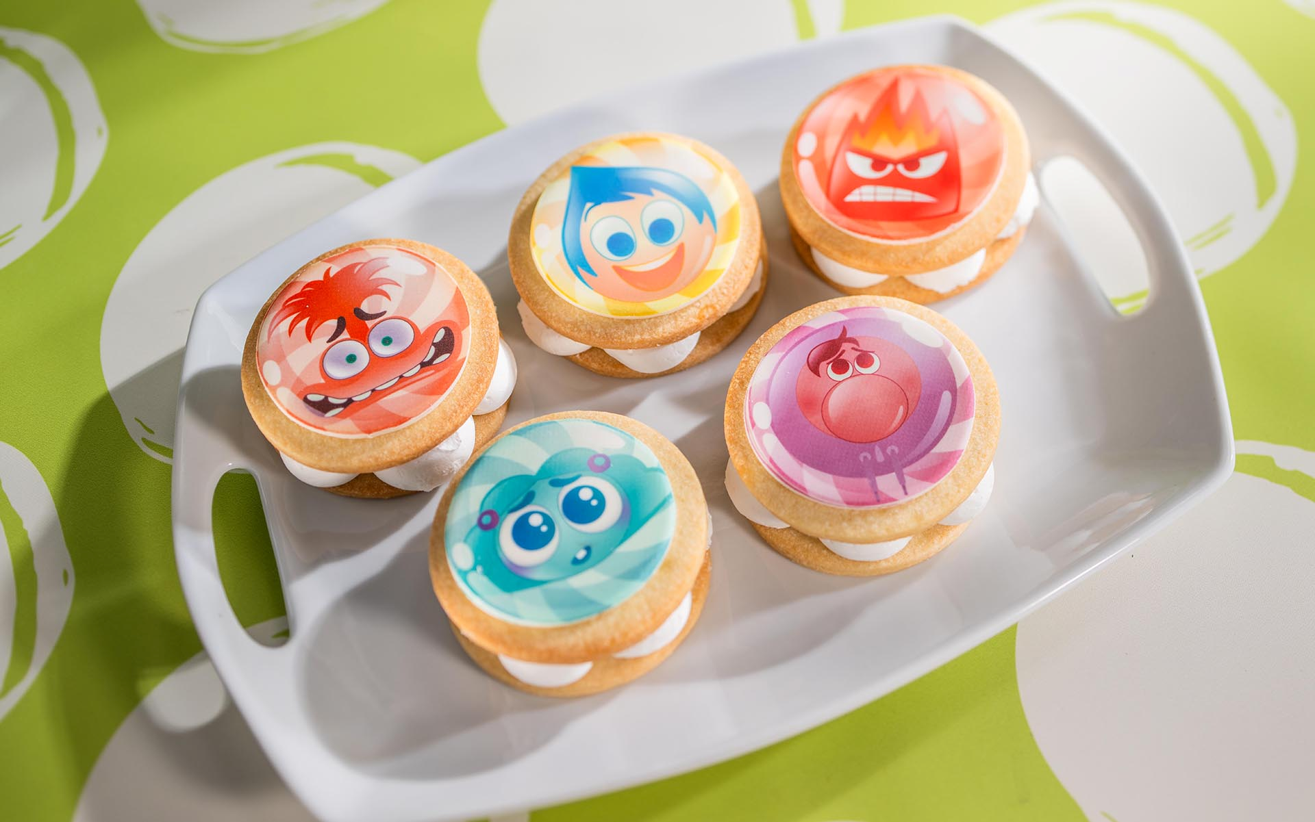 Five Inside Out shortbread sandwich cookies printed with Anxiety, Joy, Anger, Envy and Embarrassment