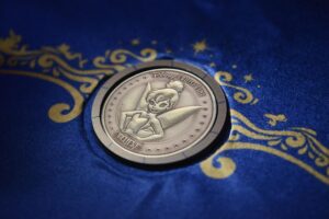 The custom-minted Tinker Bell coin for the Disney Believe keel laying ceremony
