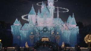 Sleeping Beauty Castle covered in snow and icicles with a swirl of light in Disneyland's 2026 holiday commercial