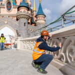 Crews working on the restored Sleeping Beauty Castle bridge at Disneyland Paris