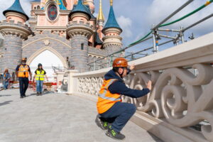 Crews working on the restored Sleeping Beauty Castle bridge at Disneyland Paris